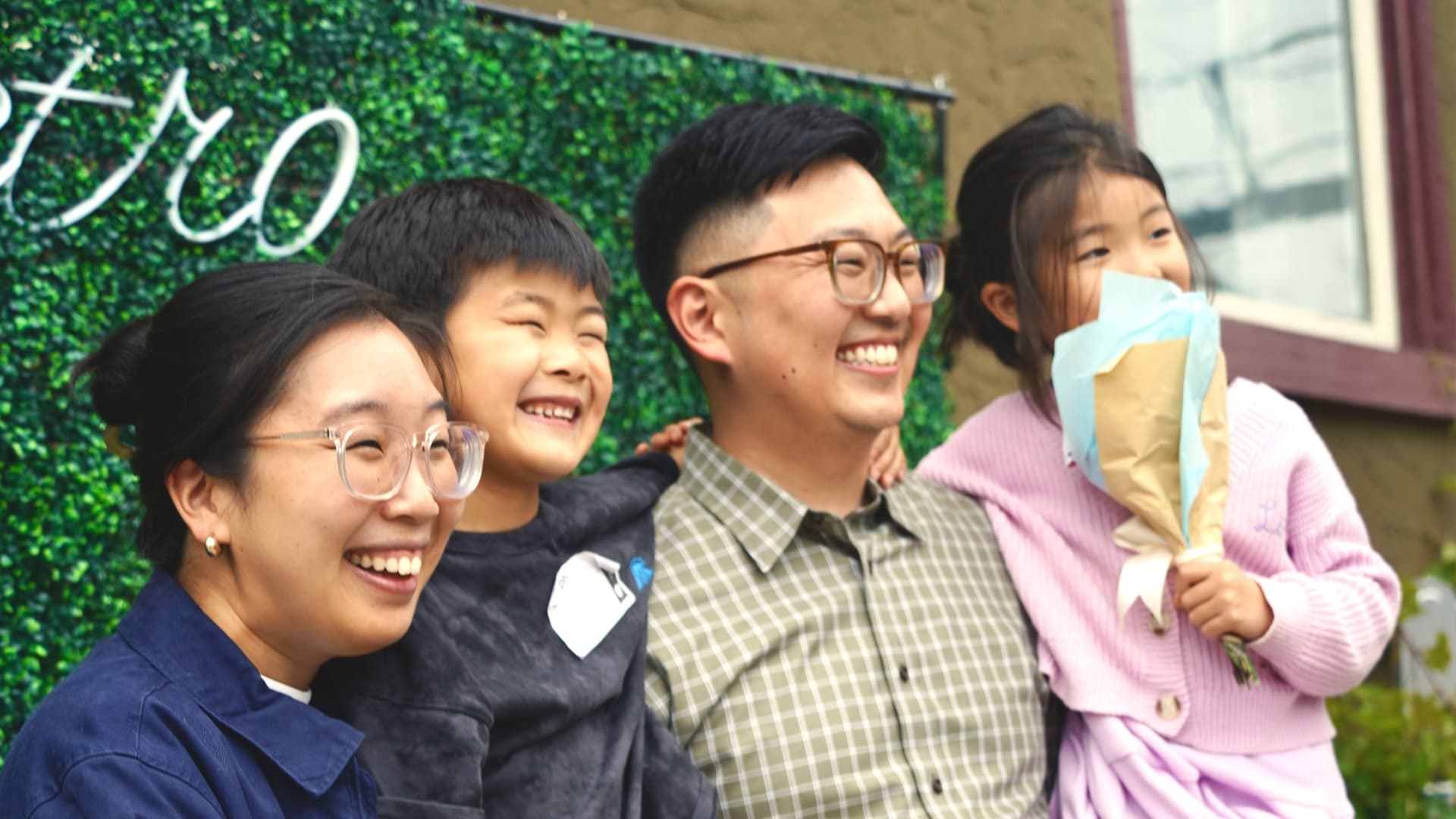 A family of four smiling together at a Metro Church event